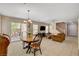 Open-concept living room with dining area, sliding glass door, and staircase at 11919 Jersey Lilly St, Las Vegas, NV 89183