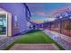 Well-manicured backyard with artificial grass and stone landscaping, great for outdoor activities at 12341 Ferry Glide Ave, Las Vegas, NV 89138