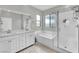 Bright bathroom with double vanity, separate shower, and soaking tub for relaxation at 12341 Ferry Glide Ave, Las Vegas, NV 89138