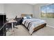 Inviting bedroom featuring a comfortable bed, natural light, and functional desk area at 12341 Ferry Glide Ave, Las Vegas, NV 89138