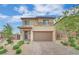 Two-story home showcasing a welcoming facade, complemented by a brick driveway and tidy landscaping at 12341 Ferry Glide Ave, Las Vegas, NV 89138
