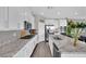 Modern kitchen with white cabinets, granite countertops, stainless steel appliances, and a large island at 12341 Ferry Glide Ave, Las Vegas, NV 89138