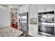 Kitchen with stainless steel appliances, white cabinets, granite countertops, and a walk-in pantry at 12341 Ferry Glide Ave, Las Vegas, NV 89138