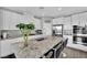 Bright kitchen featuring white cabinets, granite countertops, stainless steel appliances and an island at 12341 Ferry Glide Ave, Las Vegas, NV 89138