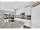 Well-lit kitchen with white cabinets, granite countertops, and stainless steel appliances at 12341 Ferry Glide Ave, Las Vegas, NV 89138