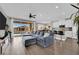 Open-concept living room boasts lots of seating, natural light, and seamless access to the outdoor pool at 12341 Ferry Glide Ave, Las Vegas, NV 89138