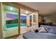An inviting living room view leading out to a patio with a luxurious pool and mountain views at 12341 Ferry Glide Ave, Las Vegas, NV 89138