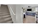 Staircase leading up to the open floorplan with a large gray sectional sofa and kitchen at 12341 Ferry Glide Ave, Las Vegas, NV 89138