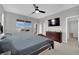 Spacious main bedroom featuring neutral paint, plush carpet, and a ceiling fan at 12341 Ferry Glide Ave, Las Vegas, NV 89138