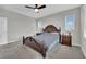 Spacious main bedroom featuring neutral paint, plush carpet, and a ceiling fan at 12341 Ferry Glide Ave, Las Vegas, NV 89138