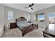 Spacious main bedroom featuring neutral paint, plush carpet, and a ceiling fan at 12341 Ferry Glide Ave, Las Vegas, NV 89138