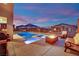 Backyard area featuring a pool, jacuzzi, and covered seating area at 12341 Ferry Glide Ave, Las Vegas, NV 89138