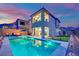 A beautiful backyard view featuring a refreshing pool with a lounge area and well-maintained landscaping at 12341 Ferry Glide Ave, Las Vegas, NV 89138