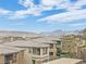 A street view exhibiting hillside homes, showcasing their exterior designs and surrounding landscape at 12341 Ferry Glide Ave, Las Vegas, NV 89138