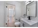 Bathroom featuring a white vanity with black faucet and a view of an opened door at 1401 E Clark Ave, Las Vegas, NV 89101