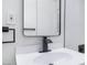 Modern bathroom vanity featuring a black faucet and hardware, paired with white tile at 1401 E Clark Ave, Las Vegas, NV 89101