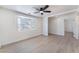 Bright bedroom featuring sleek laminate floors, a ceiling fan and a bay window at 1401 E Clark Ave, Las Vegas, NV 89101