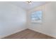 Clean bedroom design featuring wood floors, white walls, and a modern light fixture at 1401 E Clark Ave, Las Vegas, NV 89101