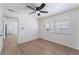 Well-lit bedroom with light wood floors, ceiling fan, and double windows at 1401 E Clark Ave, Las Vegas, NV 89101