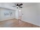 Bedroom featuring ceiling fan, window, and wood flooring at 1401 E Clark Ave, Las Vegas, NV 89101