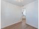 Bedroom featuring wood floors, white walls, modern light fixture, and kitchen access at 1401 E Clark Ave, Las Vegas, NV 89101