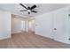 Bright bedroom featuring sleek laminate floors, a ceiling fan and white trim at 1401 E Clark Ave, Las Vegas, NV 89101