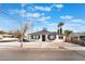 Charming single story home with a gravel yard and palm trees in the front at 1401 E Clark Ave, Las Vegas, NV 89101