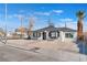 Charming single story home with a gravel yard and palm tree in the front at 1401 E Clark Ave, Las Vegas, NV 89101