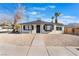 Charming single story home with a gravel yard and palm trees in the front at 1401 E Clark Ave, Las Vegas, NV 89101