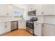 Well-lit kitchen with stainless steel appliances, white cabinets, and a large window at 1401 E Clark Ave, Las Vegas, NV 89101