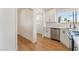 Modern kitchen featuring stainless steel appliances, white cabinetry, and a bright window at 1401 E Clark Ave, Las Vegas, NV 89101