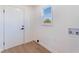 Mud room features a white door and window, alongside washer hookups at 1401 E Clark Ave, Las Vegas, NV 89101