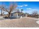 Charming single story home with a gravel yard and white fencing at 1401 E Clark Ave, Las Vegas, NV 89101
