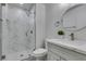 Bathroom featuring marble-tiled shower, modern vanity with marble countertop, and a round mirror at 1744 La Cruz Dr, Henderson, NV 89014