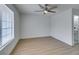 Spacious bedroom with wood-look floors, window, and doorway to an updated bathroom at 1744 La Cruz Dr, Henderson, NV 89014