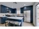 Renovated kitchen with dark blue cabinets, white countertops, stainless steel appliances, and seating at the island at 1744 La Cruz Dr, Henderson, NV 89014