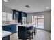Modern kitchen with dark blue cabinets, white countertops and stainless steel appliances, with an island and seating at 1744 La Cruz Dr, Henderson, NV 89014