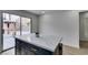Modern kitchen island with marble countertop and stylish stools leads to sliding glass doors and outdoor view at 1744 La Cruz Dr, Henderson, NV 89014