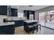 Modern kitchen featuring dark blue cabinets, white countertops, stainless steel appliances, and bar-style seating at 1744 La Cruz Dr, Henderson, NV 89014