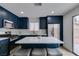 Beautiful kitchen with dark blue cabinets, modern appliances, a center island and bar-style seating at 1744 La Cruz Dr, Henderson, NV 89014