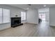 Spacious living room featuring a black brick fireplace and neutral walls with light wood floors at 1744 La Cruz Dr, Henderson, NV 89014