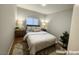 Cozy staged bedroom with a soft rug, wood floors, and soothing lighting at 1881 W Alexander Rd # 1035, North Las Vegas, NV 89032