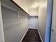 Walk-in closet with wood floor and rod and shelf system at 1881 W Alexander Rd # 1035, North Las Vegas, NV 89032