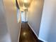 Hallway with dark wood floors and neutral-tone painted walls at 1881 W Alexander Rd # 1035, North Las Vegas, NV 89032