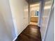 Hallway with wood floors and an open door to the bathroom at 1881 W Alexander Rd # 1035, North Las Vegas, NV 89032