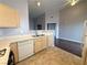 Open kitchen with laminate countertops and white appliances and breakfast bar seating at 1881 W Alexander Rd # 1035, North Las Vegas, NV 89032