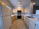 Kitchen with neutral cabinets, laminate countertops and white appliances at 1881 W Alexander Rd # 1035, North Las Vegas, NV 89032