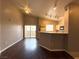 Open living room featuring hardwood floors and a kitchen with a breakfast bar at 1881 W Alexander Rd # 1035, North Las Vegas, NV 89032