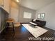 A staged living room boasts dark hardwood floors and modern furniture at 1881 W Alexander Rd # 1035, North Las Vegas, NV 89032