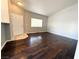 Bright, naturally lit living room featuring dark hardwood floors and neutral wall paint at 1881 W Alexander Rd # 1035, North Las Vegas, NV 89032